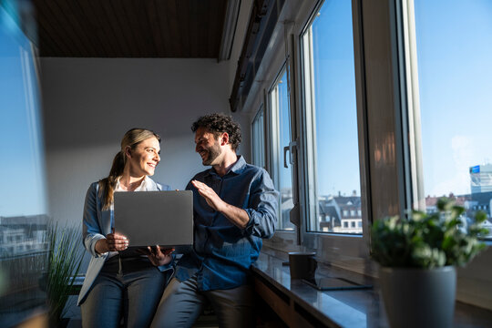 Business team brainstorming with a notebook in a sunny office