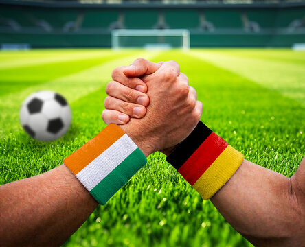 Ireland and Germany soccer teams fists together on green field