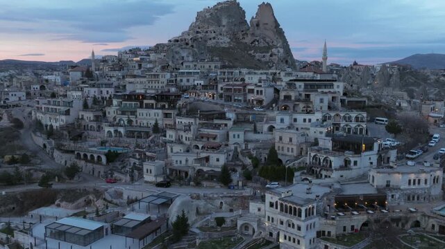 Drone view of Ortahisar Castle towering above the historic town of Ortahisar in Cappadocia, Turkey. A remarkable example of rock-carved architecture.