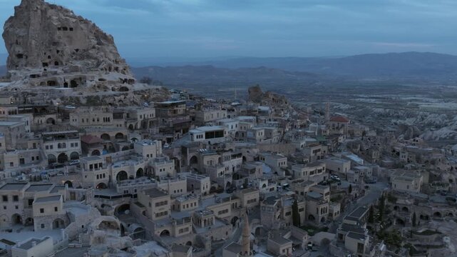 Drone view of Ortahisar Castle towering above the historic town of Ortahisar in Cappadocia, Turkey. A remarkable example of rock-carved architecture.