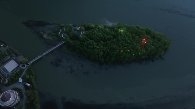 High angle drone shot of Anaklia coastal resort in Georgia, showing the famous pedestrian bridge, green river island, and scenic sea delta landscape.