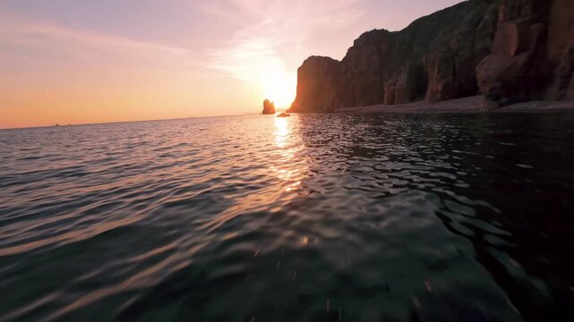 fpv drone flies low over the water of a large sea against the background of the setting sun fast flight over the water waves reflect the sunset evening. High quality 4k footage nobody towards the sun.