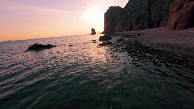 fpv drone flies low over the water of a large sea against the background of the setting sun fast flight over the water waves reflect the sunset evening. High quality 4k footage nobody towards the sun.