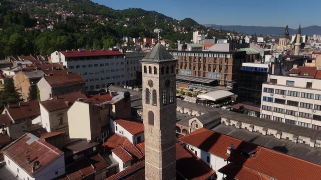 Cinematic Drone Flyby of Historic Sarajevo Clock Tower, Close Aerial Tracking Shot of Sahat Kula Lunar Time Landmark in Ba&scaron;čar&scaron;ija Old Town Bosnia, 4K Video