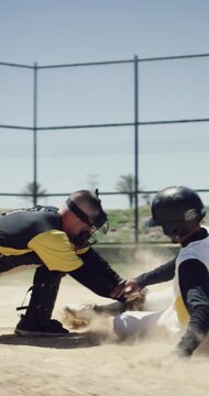Running, man and slide outdoor for baseball, fitness and competition with game action. Athlete, people or defensive play on field with speed, tag avoidance and ball for base shot of sports tournament