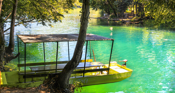 Yellow tourist boat on the Una River at Japodski Otoci near Bihac Bosnia and Herzegovina
