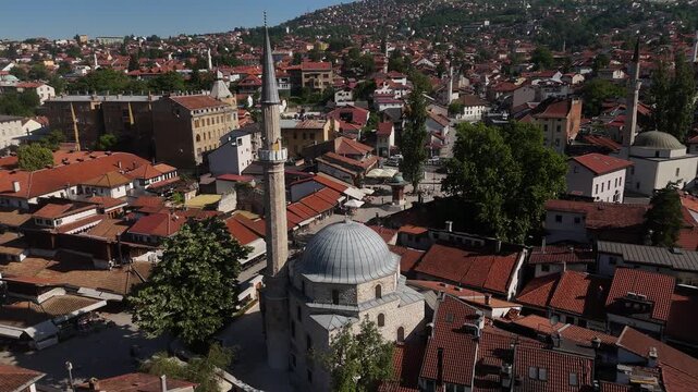 Cinematic Drone Flyby of Mosque Minaret to Reveal Bascarsija Square, Aerial View with Orbit Past Ottoman Landmark and Pedestrian Marketplace in Sarajevo, 4K