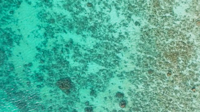 Sun reflection over turquoise water with coral reefs. Santa Fe, Tablas, Romblon. Philippines.