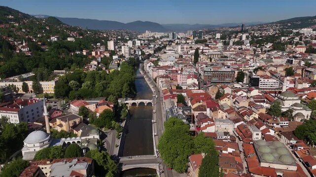 Cinematic Drone Flight over Latin Bridge, Forward Aerial Push with Camera Tilt Up Revealing Miljacka River and Historic Old Town Skyline in Sarajevo Bosnia, 4K