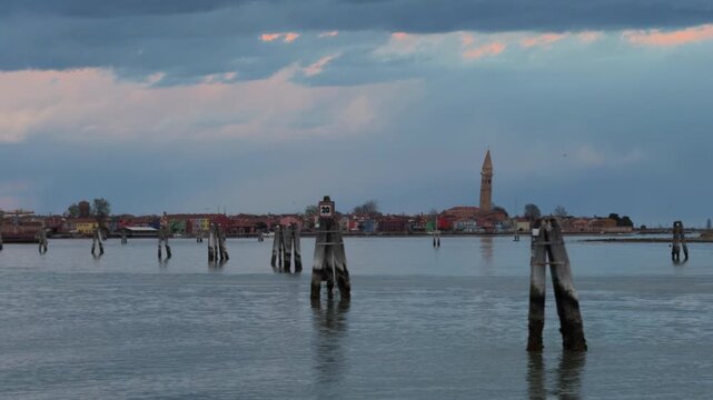 Slow Motion Coastal Canal With Church Tower Under Clouds