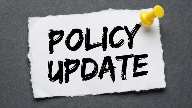 Policy update text on crumpled paper with yellow pushpin