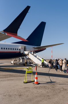People Boarding a Flight At Sunny Day
