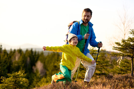 Father and child hiking in the mountains