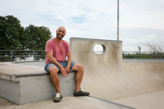 Smiling positive skateboarder portrait