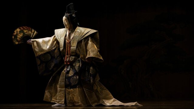  A Noh theater performer in an elaborate costume on stage. 