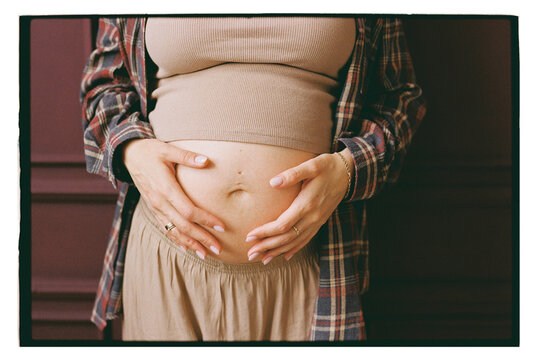 A pregnant woman holds her belly