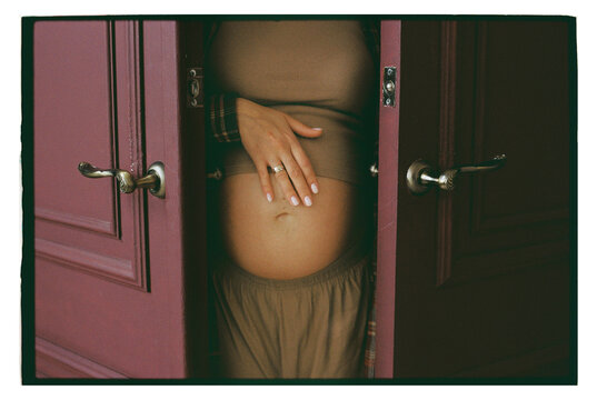 The expectant mother is between the doors.