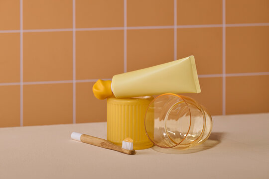 Minimalist bathroom scene with yellow toothpaste tube, toothbrush