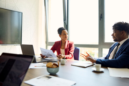 Colleagues talking in a bright office