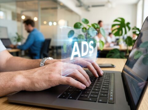 Digital advertising concept hands typing on laptop with 'ads' hologram