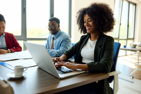 Smiling woman taking notes in a meeting