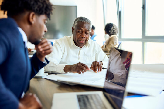 Senior employee works with his colleague