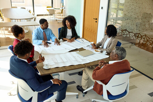 Group Discusses Project Plans Around Conference Table