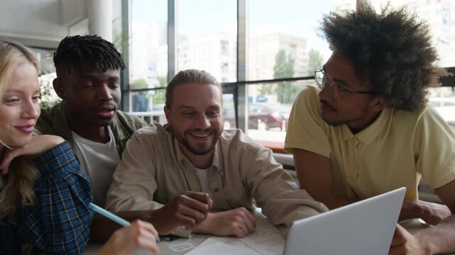 Five happy multiracial students classmates emotional discussing online homework task talking smiling looking in laptop talk diversity friends with computer studying e-learning in university college