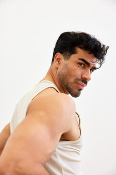 Man posing indoors with a relaxed look and focused expression