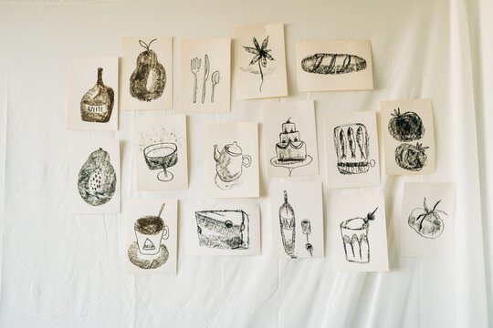 Black and white sketch collection displayed on wall in art studi