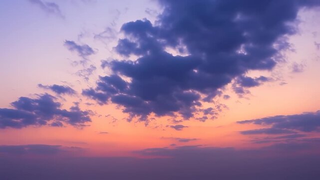 A dramatic sky with layers of clouds against a vibrant orange and purple gradient sunset