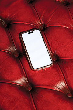 Mock-up phone with empty screen on red leather background