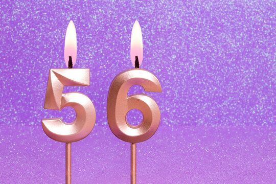 Number 56 on a pink background with blurred bright dots - Birthday or anniversary card with abstract blurred dots that glow