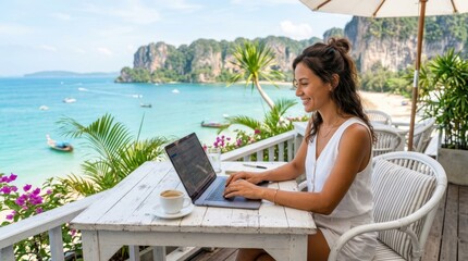 Obraz premium Woman working on laptop at a tropical beach cafe with ocean view