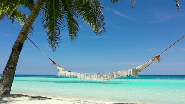 Beautiful beach with hammock and blue sea in Panglao island, Bohol, Philippines. Holiday and vacation concept. Tropical beach.