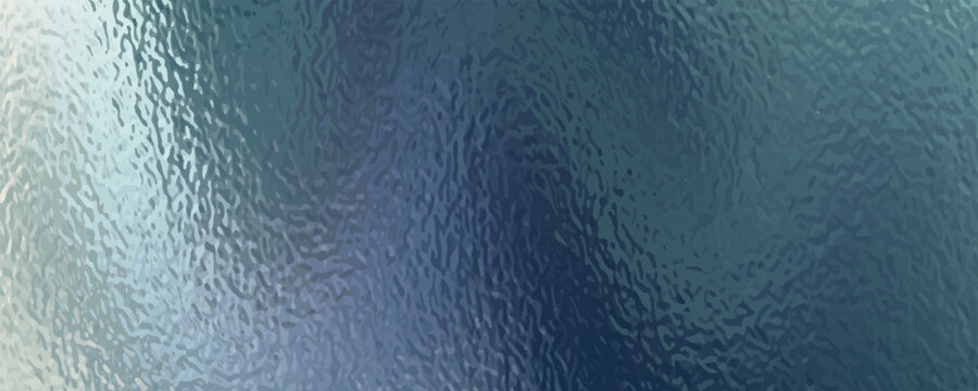 A close-up view of a textured surface, possibly frosted glass, with swirling patterns of blue and green.