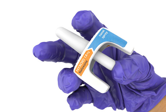 A doctor holds Nyxoid, a naloxone nasal spray used for emergency opioid overdose reversal. This product is used in healthcare, addiction treatment, public health, and pharmaceuticals.