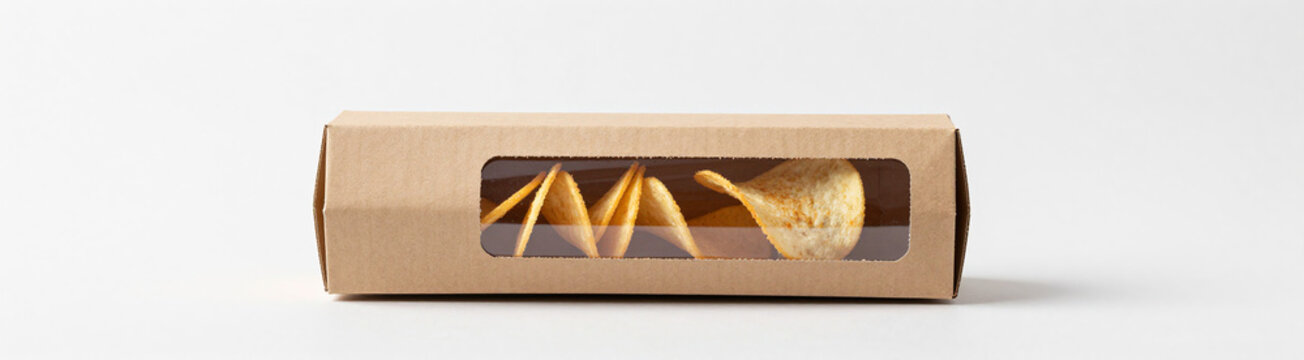 photorealistic image blank open cardboard cylinder box clear plastic window side containing tube crispy potato chips