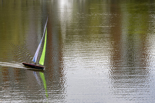 Remote sailboat on lake surface in daytime with copy space