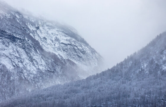 A beautiful misty mountain landscape with low clouds. A wintertime scenery in Geiranger Unesco World heritage area, Sunnmore, More og Romsdale, Norway.