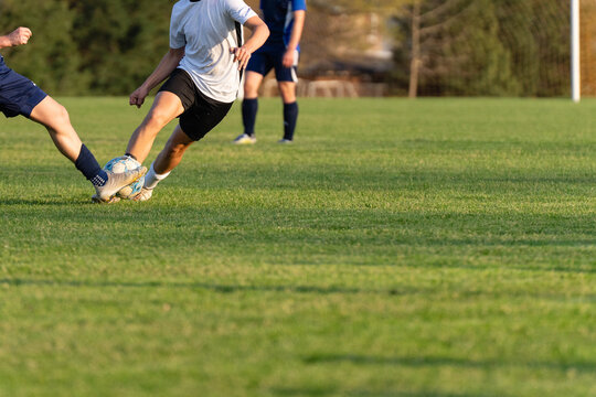 Soccer Players Competing for Ball on Grass Field with Copy Space