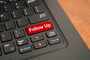 Fototapeta premium Follow up concept on computer keyboard with highlighted red key, representing customer engagement, sales communication, lead management, and business process continuation.