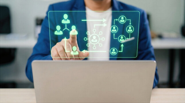 Businessman touching interface with team structure and hierarchy diagram above laptop. Human resources, recruitment, and leadership management network for corporate workflow and talent strategy.