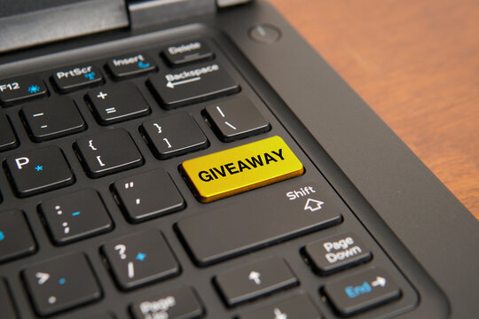 Close up of a computer keyboard with a yellow giveaway key, representing promotional campaigns, prize distributions, customer engagement, marketing incentives, and brand awareness concepts.