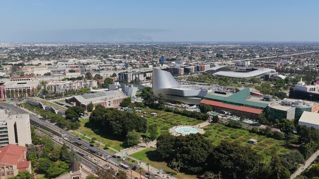 Cinematic orbit showcasing Exposition Park in Los Angeles with California Science Center, Natural History Museum, BMO Stadium, Lucas Museum of Narrative Art construction