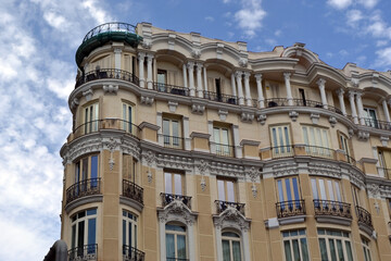 Close up of ornate facade detail with balconies and columns on madrid upper floors for architectural background and design. Gran Via of Madrid © iri.madrid.art
