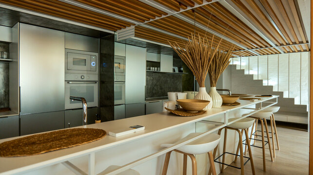 Modern kitchen island with sleek cabinetry and a contemporary staircase design