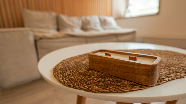 Aesthetic wooden wick candle in a minimalist living room setting