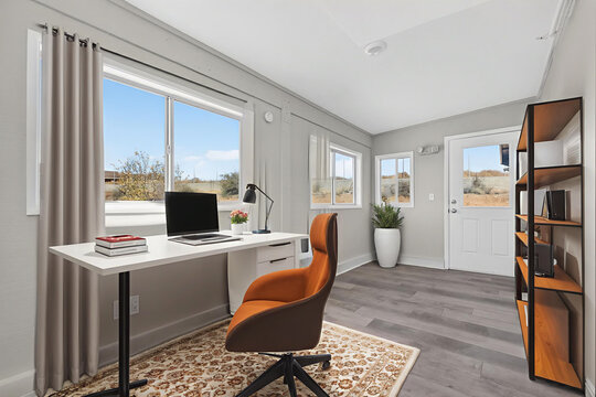 Modern home office with desk and orange chair