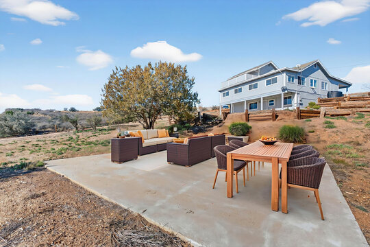 Outdoor patio with seating and hillside home